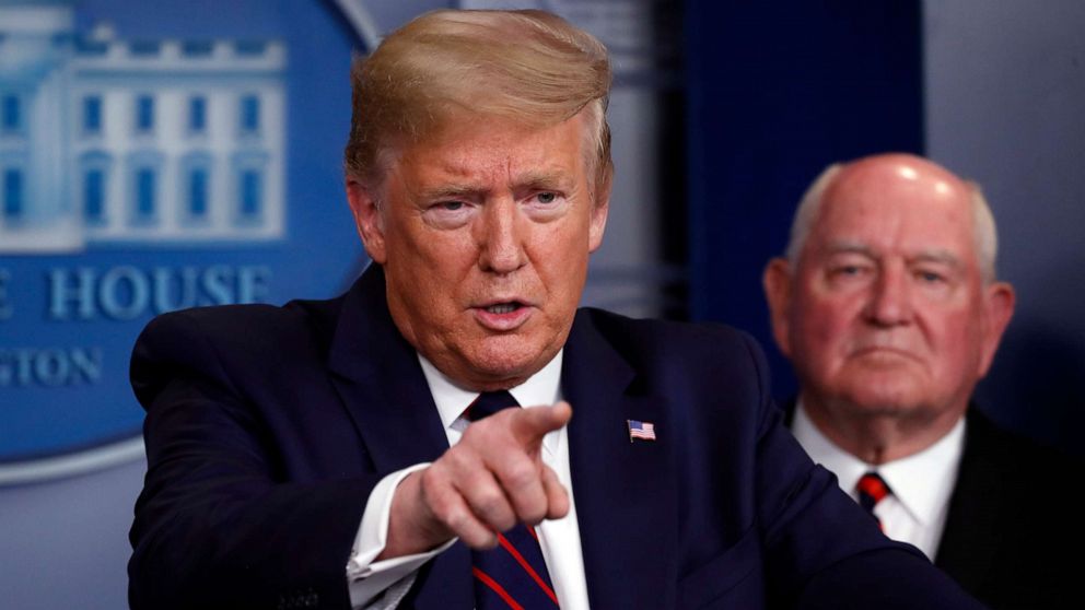 PHOTO: President Donald Trump speaks about the coronavirus in the James Brady Press Briefing Room, March 27, 2020, in Washington as Agriculture Secretary Sonny Perdue listens.