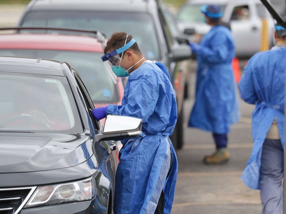 PHOTO: Members of the Wisconsin National Guard takes a test sample at a COVID-19 testing site located at the United Migrant Opportunity Services (UMOS) building in Milwaukee, Sept. 29, 2020. 