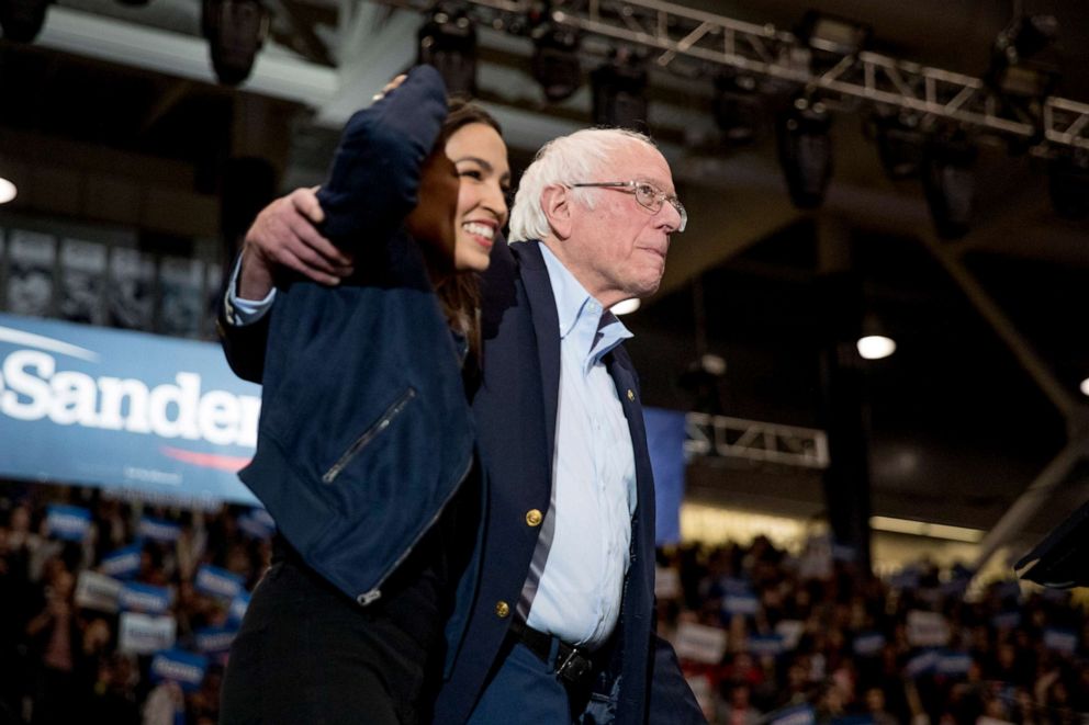 PHOTO: Democratic presidential candidate Sen. Bernie Sanders, accompanied by Rep. Alexandria Ocasio-Cortez, left, takes the stage at campaign stop at the Whittemore Center Arena at the University of New Hampshire, Feb. 10, 2020, in Durham, N.H.