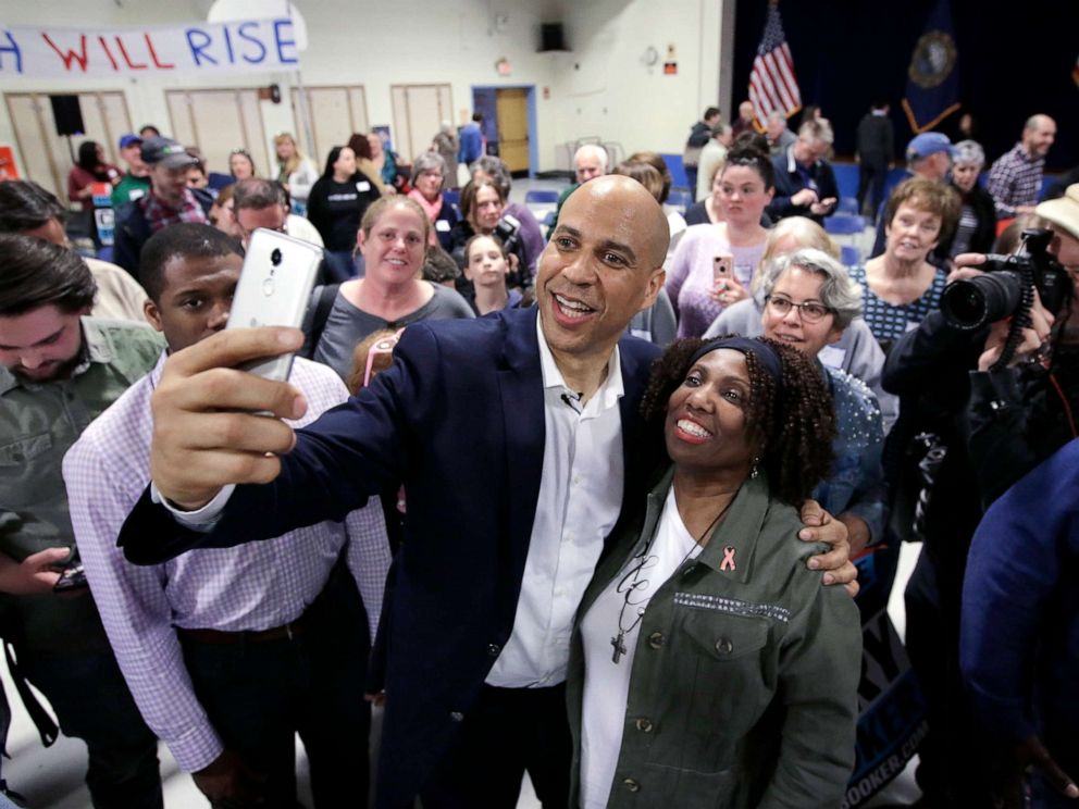 PHOTO: Sen. Cory Booker takes selfies with residents at the conclusion of a 2020 presidential campaign stop, April 7, 2019, in Londonderry, N.H.