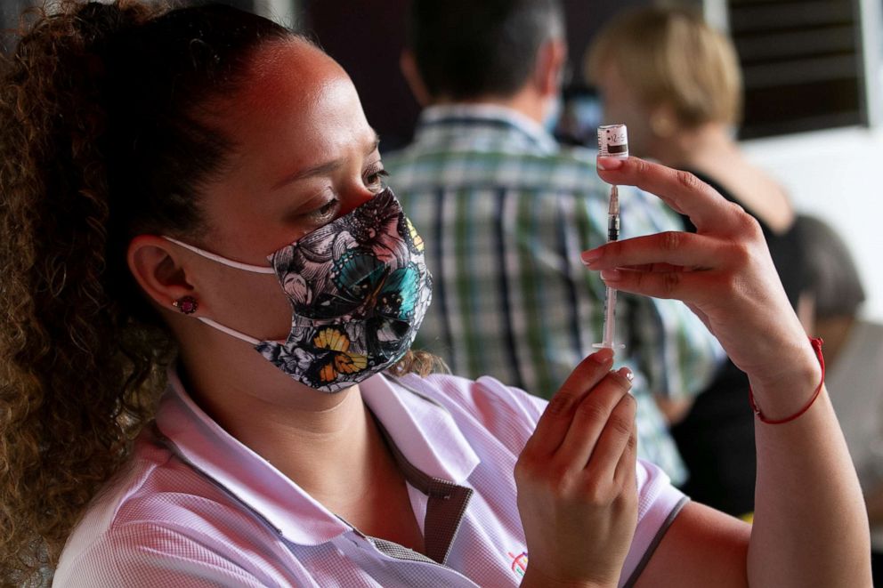 PHOTO: A nurse prepares the vaccine as part of the national vaccination campaign against COVID-19, May 7, 2021, in Escazu, Costa Rica. 