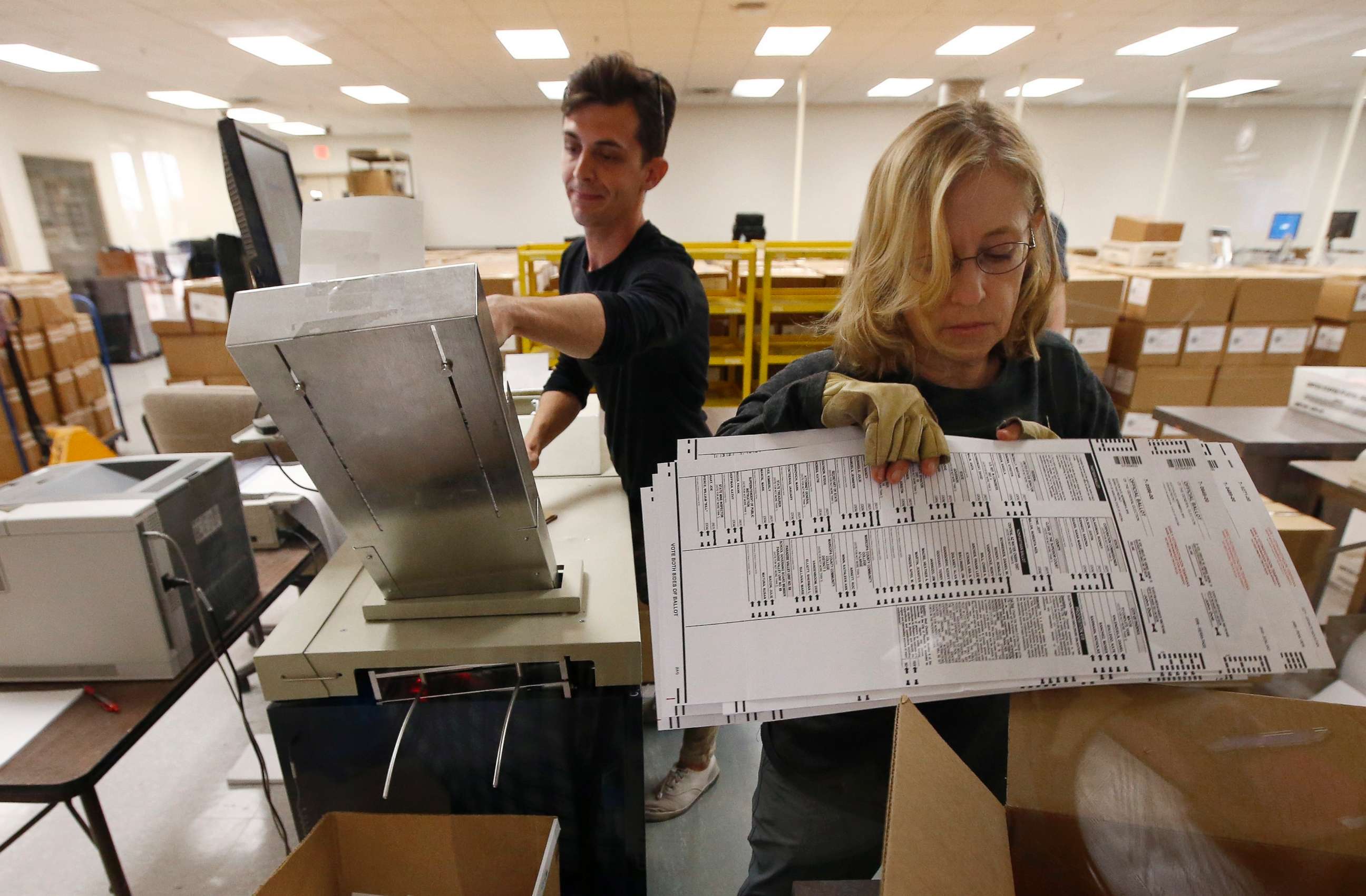 PHOTO: Workers organize ballots at the Maricopa County Recorder's Office Thursday, Nov. 8, 2018, in Phoenix.