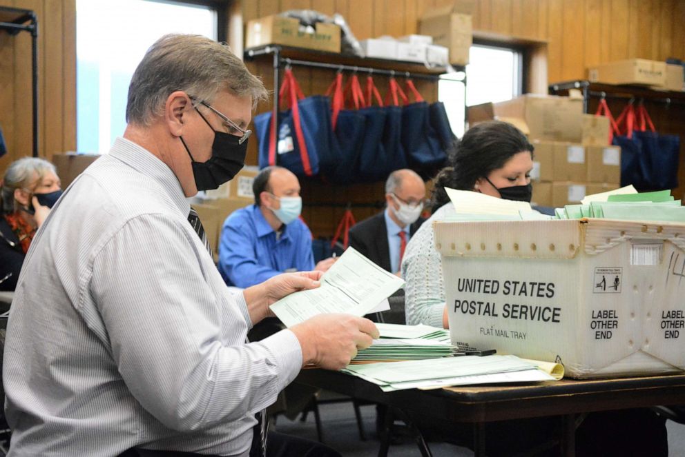 PHOTO: Election Bureau Director Albert L. Gricoski, left, opens provisional ballots next to election bureau staff Christine Marmas, right, while poll watchers observe from behind at the Schuylkill County Election Bureau in Pottsville, Pa., Nov. 10, 2020.