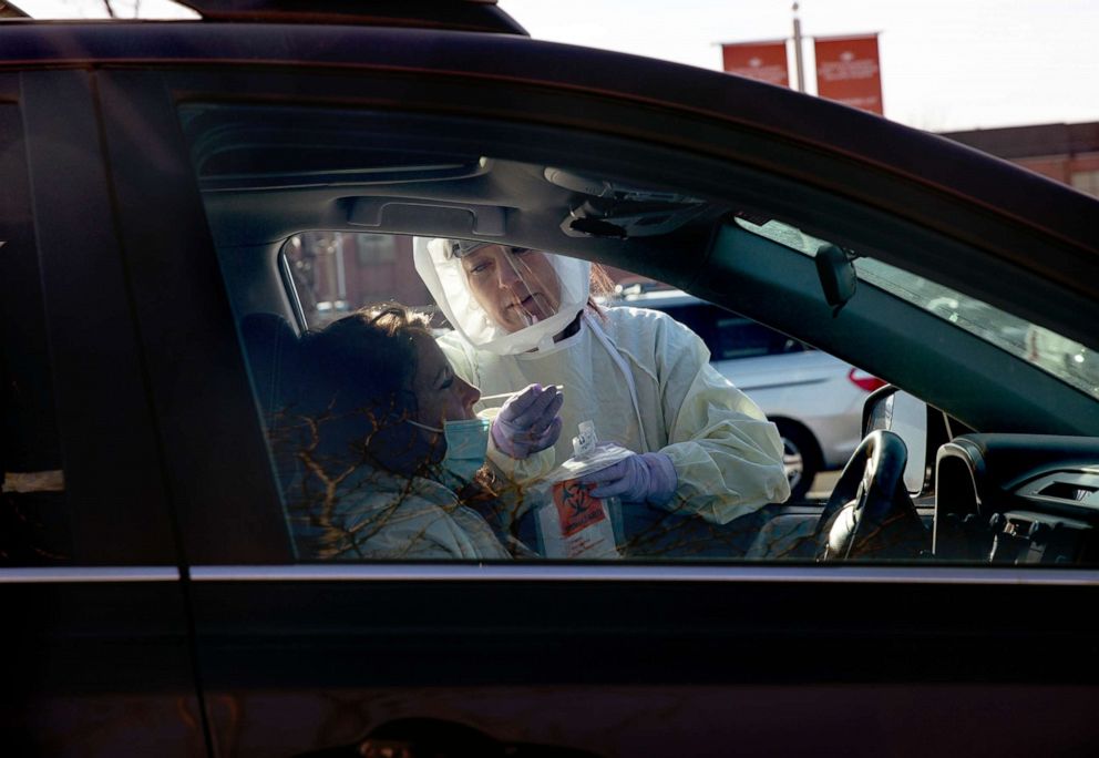 PHOTO: A health care worker performs a COVID-19 swab test at an Intermountain Healthcare testing center in Murray, Utah on Jan. 14, 2021.