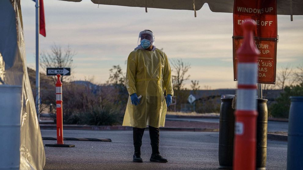 PHOTO: A healthcare worker waits for the next patient at a drive-thru Covid-19 testing site in El Paso, Texas, Jan. 12, 2022. 