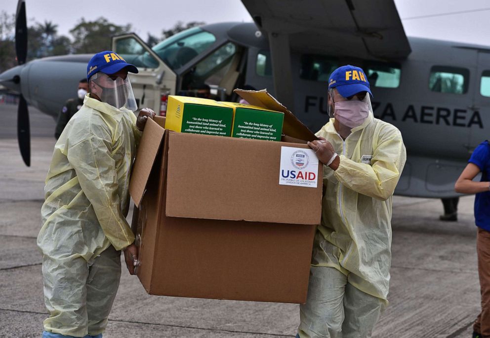 PHOTO: Members of the Honduran Armed Forces carry a box containing diagnostic testing kits donated by the U.S. Agency for International Development and the International Organization for Migration, in Tegucigalpa, Honduras, April 29, 2020.