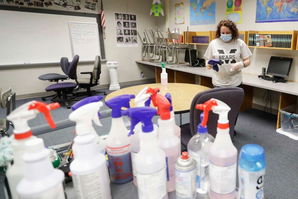 PHOTO: In this June 22, 2020, file photo, Charo Woodcock cleans a classroom at McClelland Elementary School, in Indianapolis.