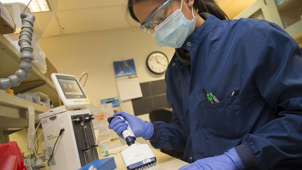 PHOTO: Medical laboratory scientist, Alicia Bui, runs a clinical test in the Immunology lab at UW Medicine looking for antibodies against SARS-CoV-2, a virus strain that causes coronavirus disease (COVID-19) on April 17, 2020, in Seattle.
