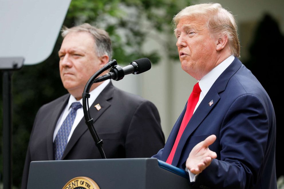 PHOTO: President Donald Trump speaks as Mike Pompeo, U.S. secretary of state, left, listens during a news conference in the Rose Garden of the White House, May 29, 2020. 