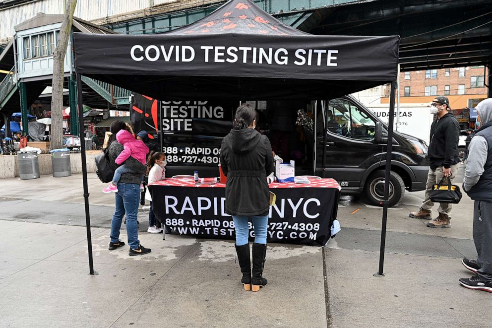 PHOTO: In this April 12, 2021, file photo, a woman waits in line to take a rapid COVID-19 test in the Queens borough of New York.