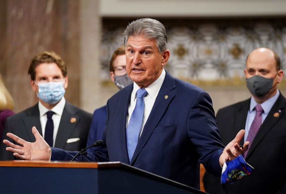 PHOTO: Sen. Joe Manchin removes his mask to speak as bipartisan members of the Senate and House gather to announce a framework for fresh coronavirus disease  relief legislation at a news conference on Capitol Hill.
