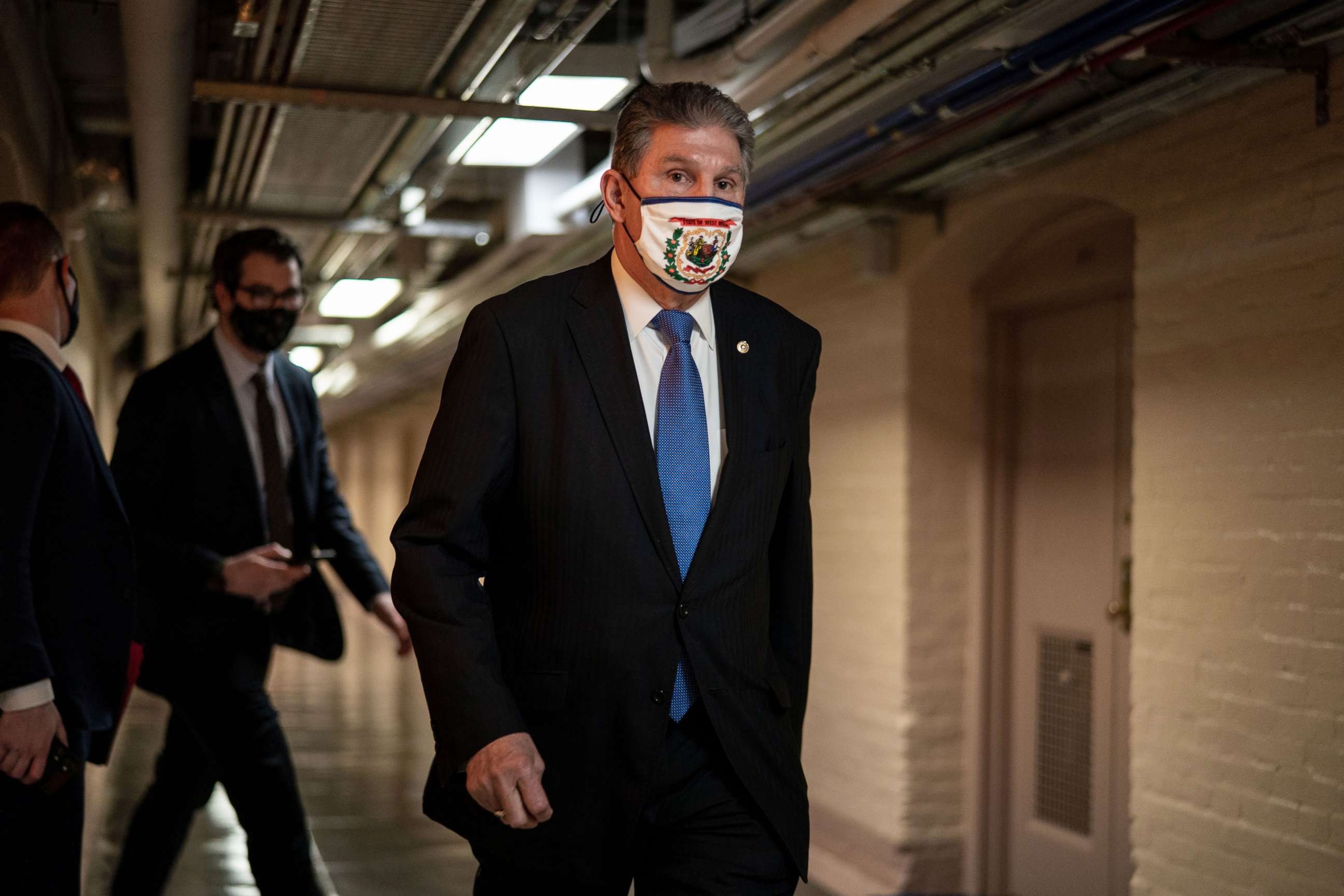 PHOTO: Sen. Joe Manchin walks on the senate side of the Capitol Building on Friday, March 5, 2021.