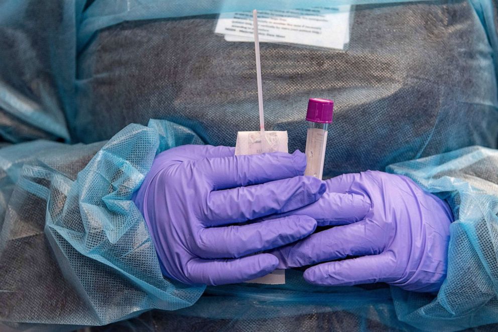 PHOTO: A medical worker prepares a Covid-19 PCR test at East Boston Neighborhood Health Center in Boston, on Dec. 20, 2021.