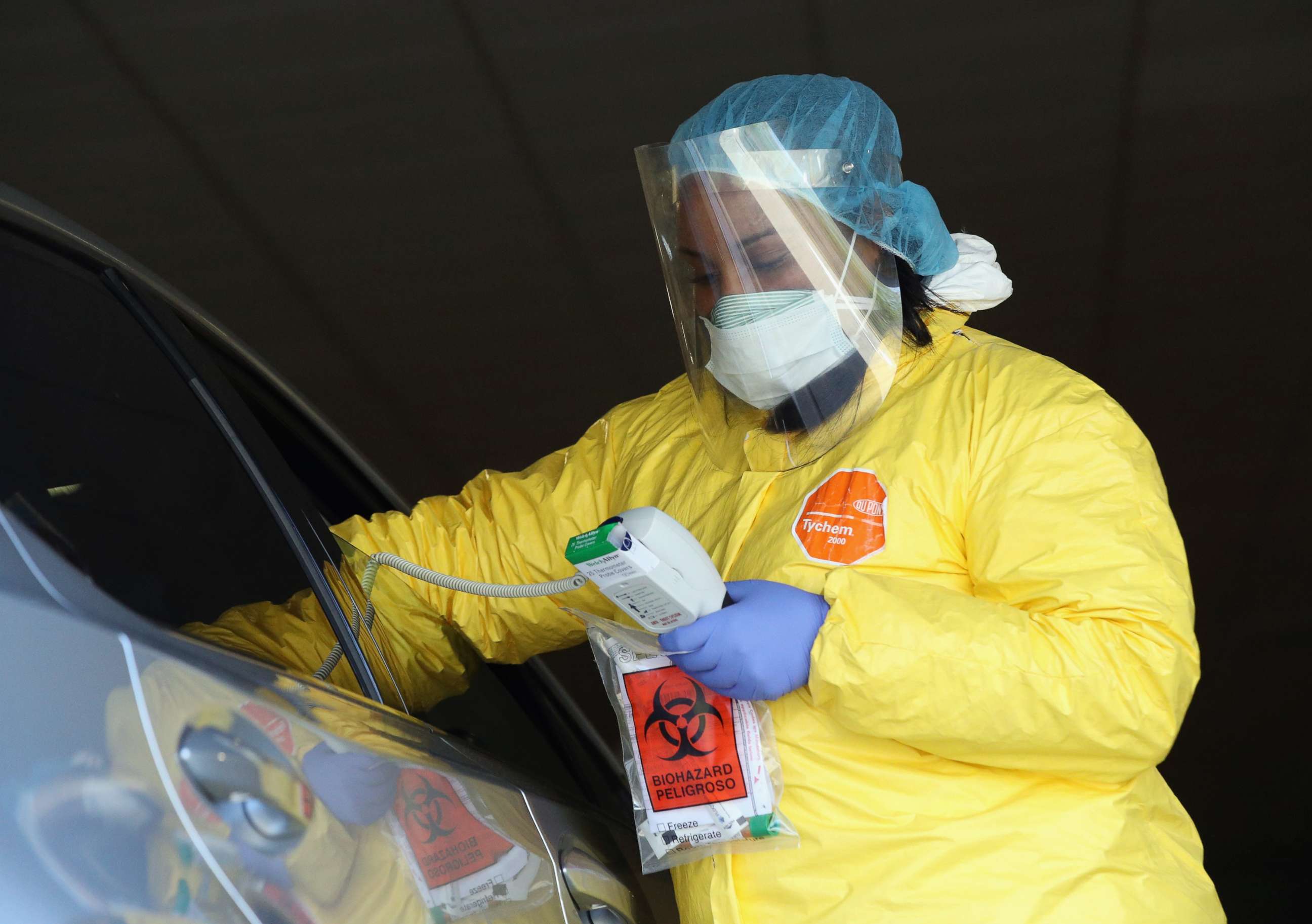 PHOTO: Health care workers tend to drive-in patients at the ProHEALTH Care coronavirus testing site on April 15, 2020, in New Hyde Park, New York.