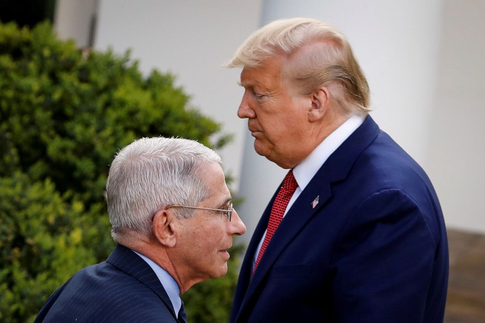 PHOTO: NIH National Institute of Allergy and Infectious Diseases Director Anthony Fauci walks past President Donald Trump during a news conference in the Rose Garden of the White House in Washington, March 29, 2020.