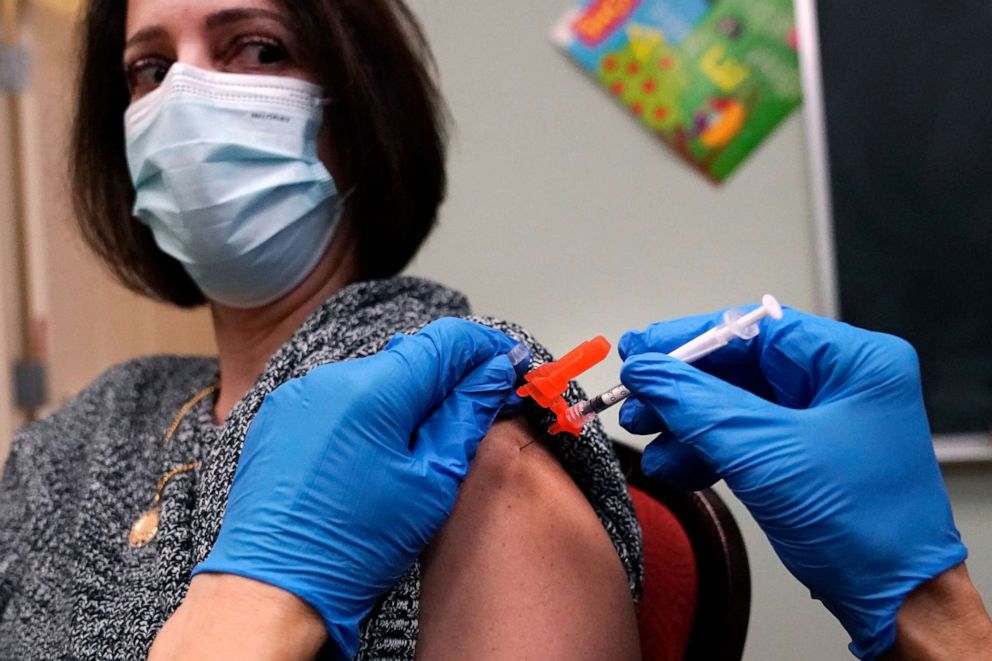 PHOTO: Yudit Guzman receives a COVID-19 vaccine dose, Dec. 29, 2021, in Lawrence, Mass.
