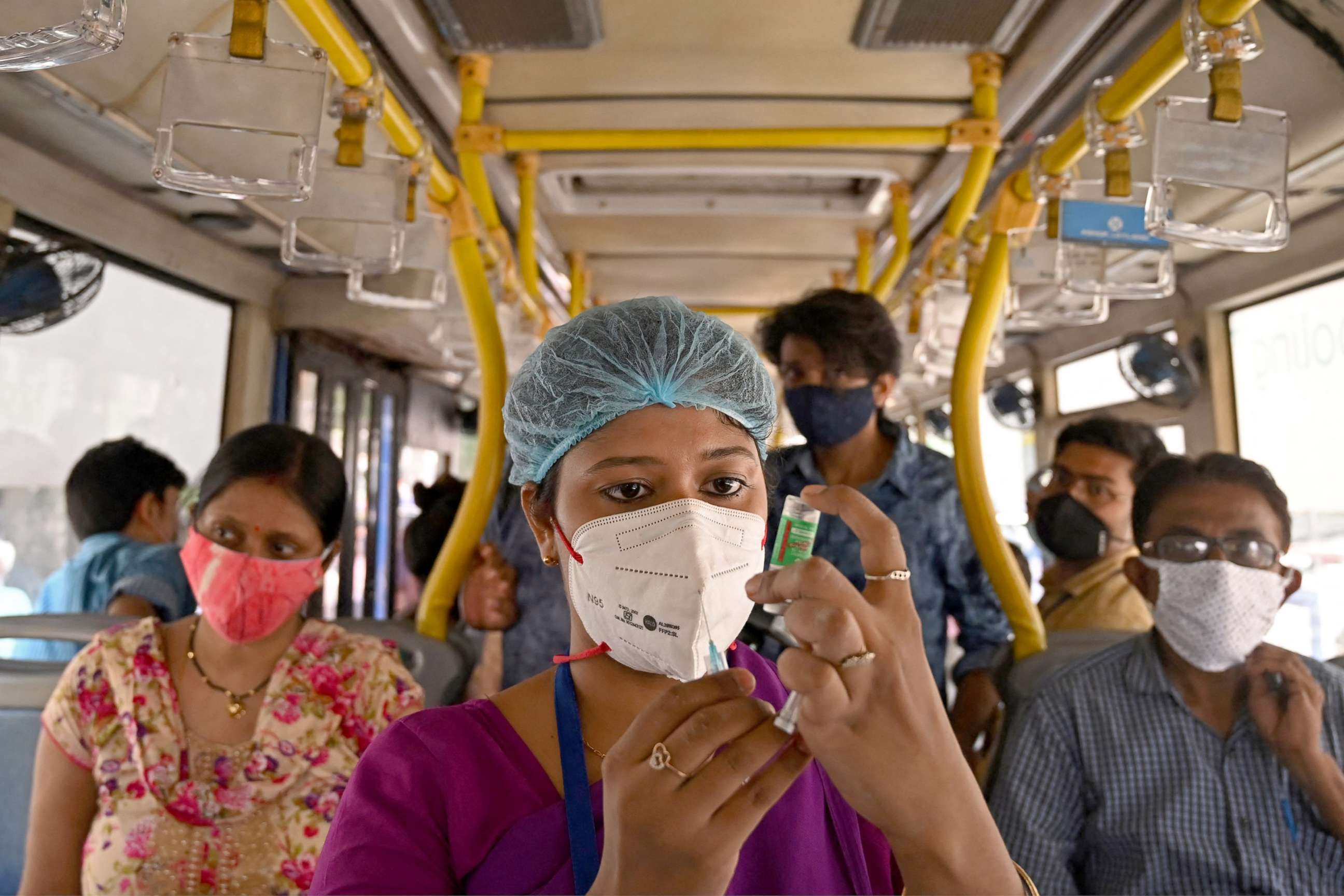 PHOTO:A health worker prepares to administer a vaccine against the COVID-19 virus in a passenger bus converted into a mobile vaccination centre in Kolkata, June 3, 2021.