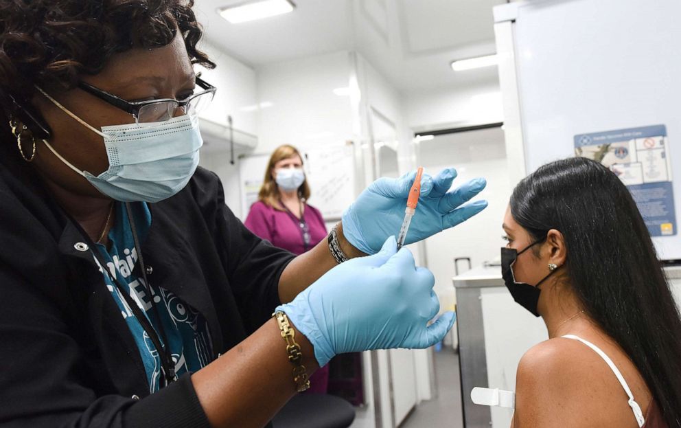 PHOTO: Nurse Carlene Fleming prepares to administer a dose of COVID-19 vaccine to a patient at a mobile vaccination event at in Orlando, Fla., July 24, 2021.