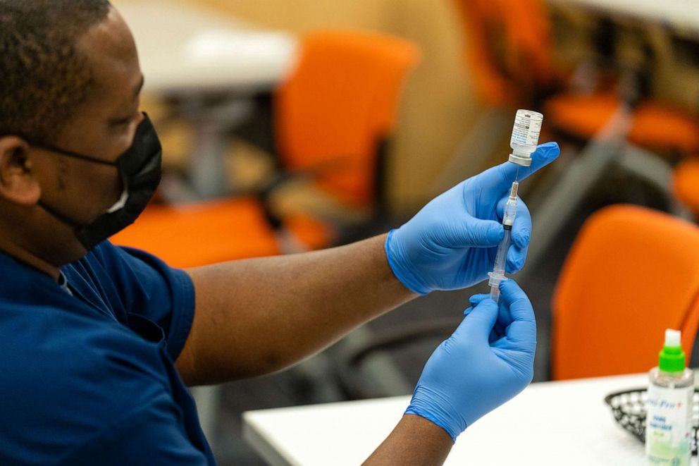 PHOTO: A healthcare employee prepares a syringe with the Moderna COVID-19 vaccine at the Dennis Avenue Health Center in Silver Spring, Maryland, on Nov. 21, 2022.