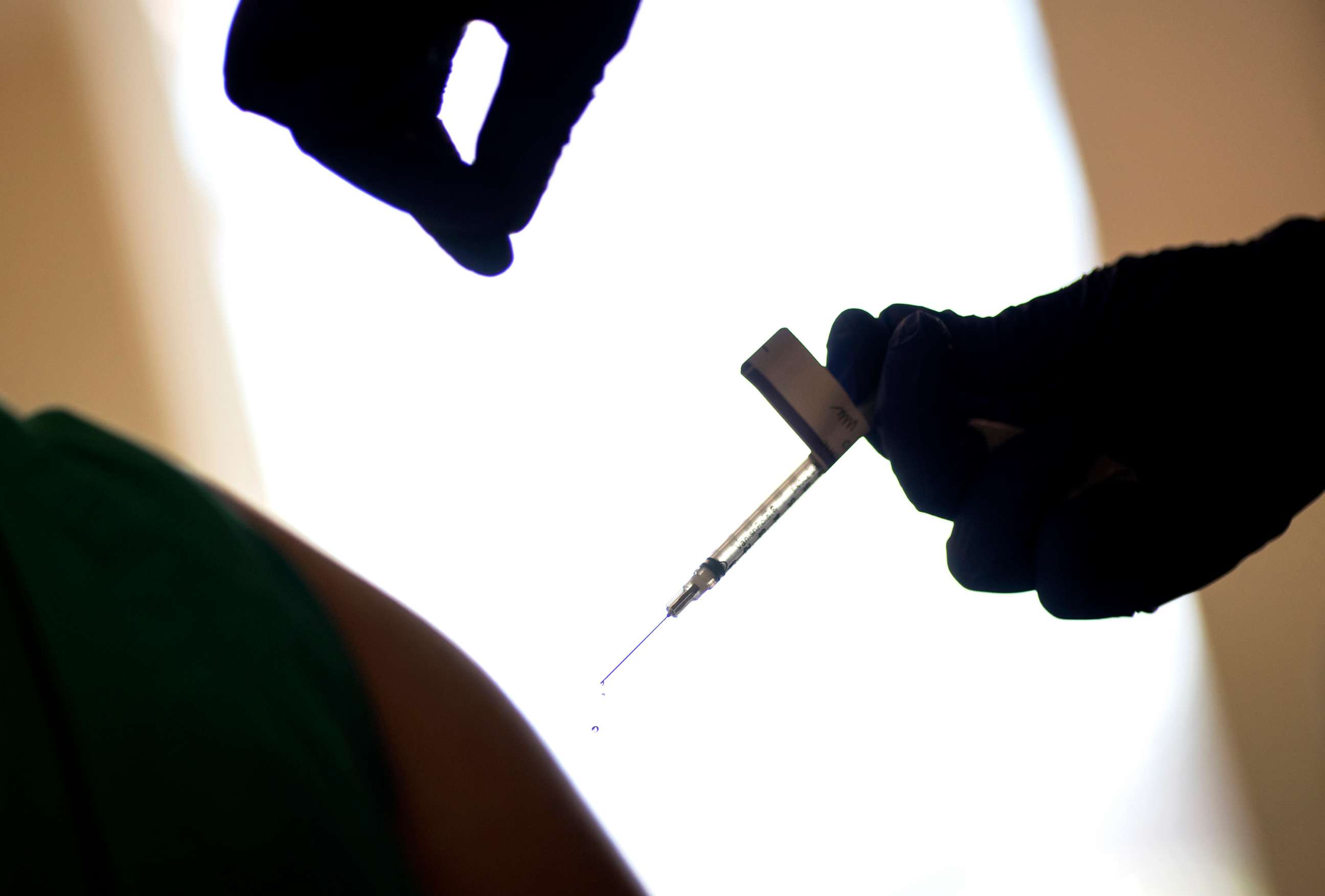 PHOTO: A droplet falls from a syringe after a health care worker was injected with the Pfizer-BioNTech COVID-19 vaccine in Providence, R.I., Dec. 15, 2020.