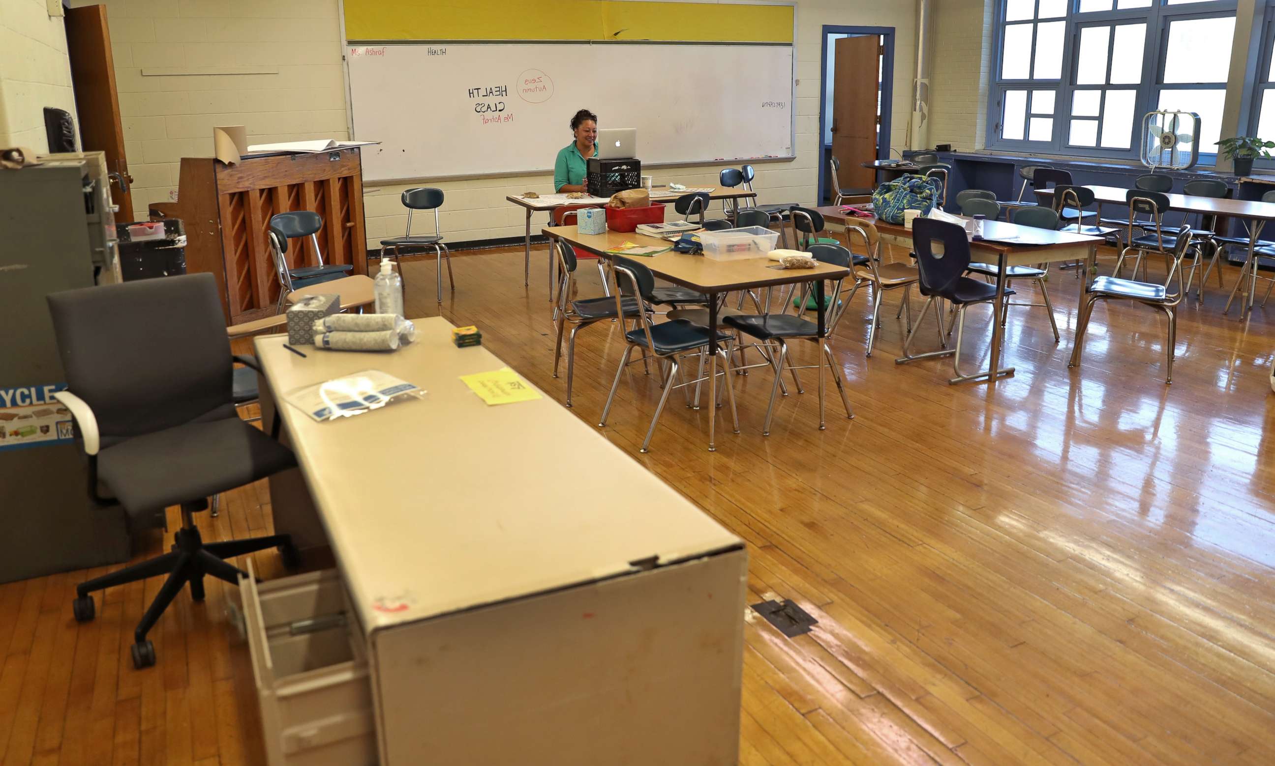PHOTO: Ms. Nilo Ashraf, a health teacher, works on remote school with 7th and 8th grade students from an empty classroom at McCormack Middle School in Boston's Dorchester on Sept. 21, 2020.