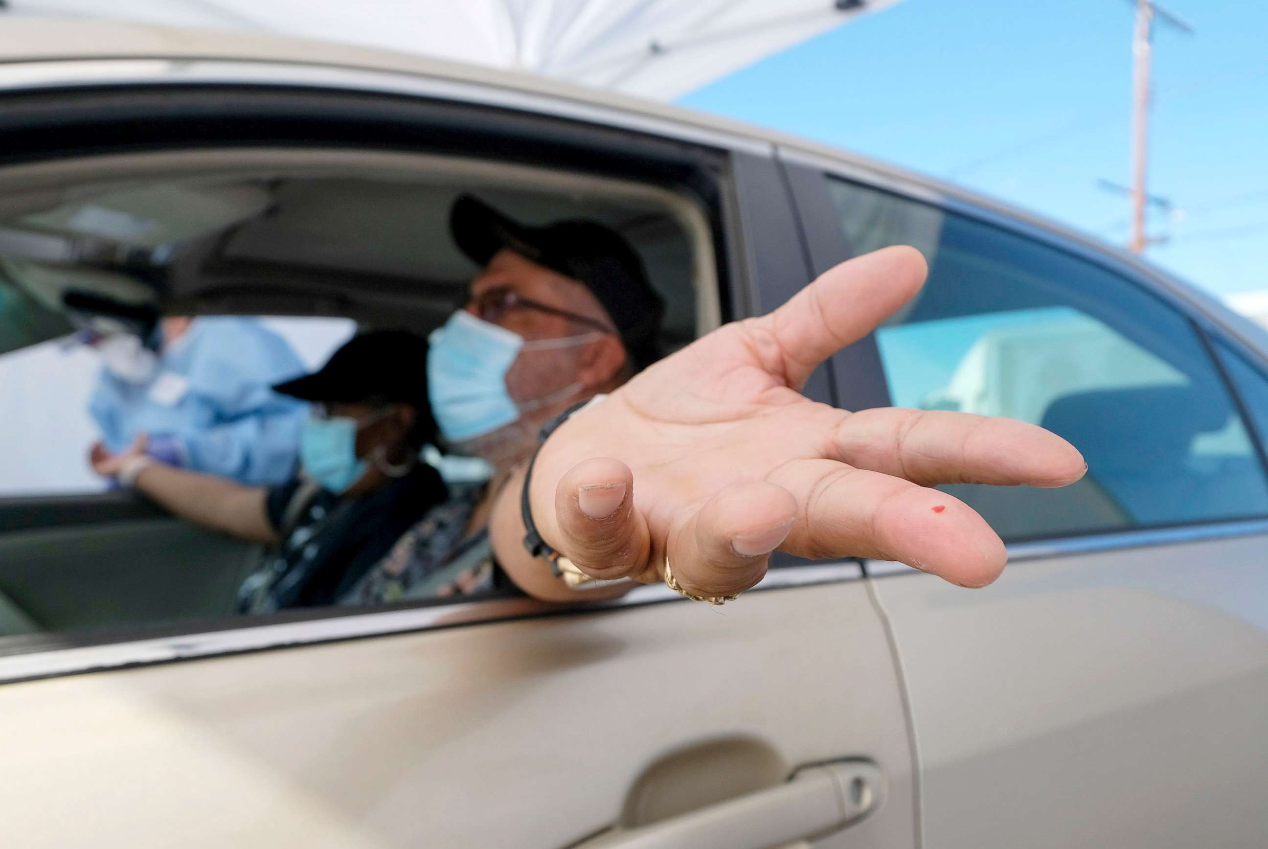 PHOTO: A motorist holds out his hand after having blood drawn at the Southside Church of Christ in Los Angeles, Jan. 18, 2021.