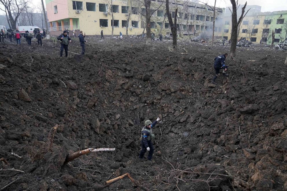 PHOTO: Ukrainian soldiers and emergency employees work at the site of the shelling of a maternity hospital in Mariupol, Ukraine, March 9, 2022.