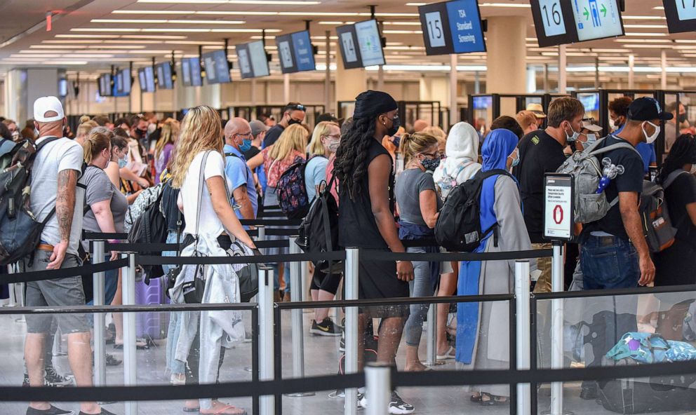 PHOTO: Travelers wait in line for TSA security screening at Orlando International Airport, July 2, 2021, in Orlando, Fla.