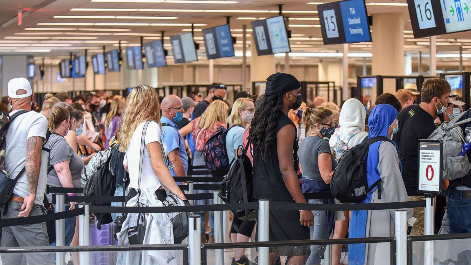 PHOTO: Travelers wait in line for TSA security screening at Orlando International Airport, July 2, 2021, in Orlando, Fla.