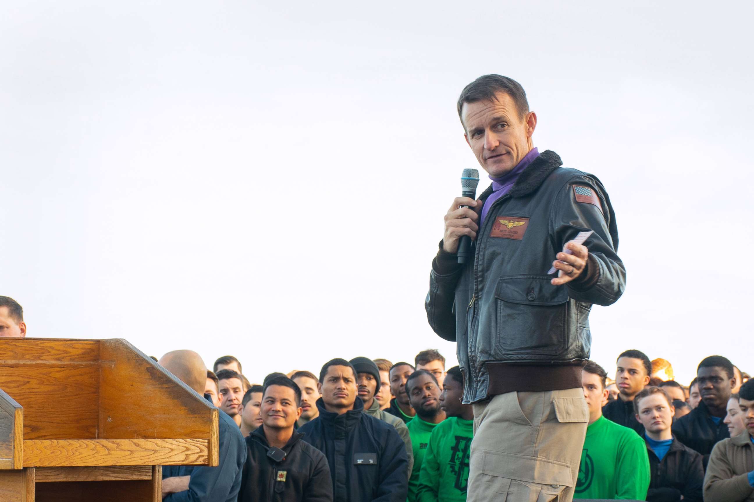 PHOTO: Capt. Brett Crozier, commanding officer of the aircraft carrier USS Theodore Roosevelt (CVN 71), gives remarks during an all-hands call on the flight deck, Dec. 15, 2019.