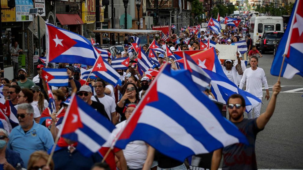 PHOTO: People wave Cuban flags as they march during a protest showing support for Cubans demonstrating against their government, in Union City, N.J, July 18, 2021.