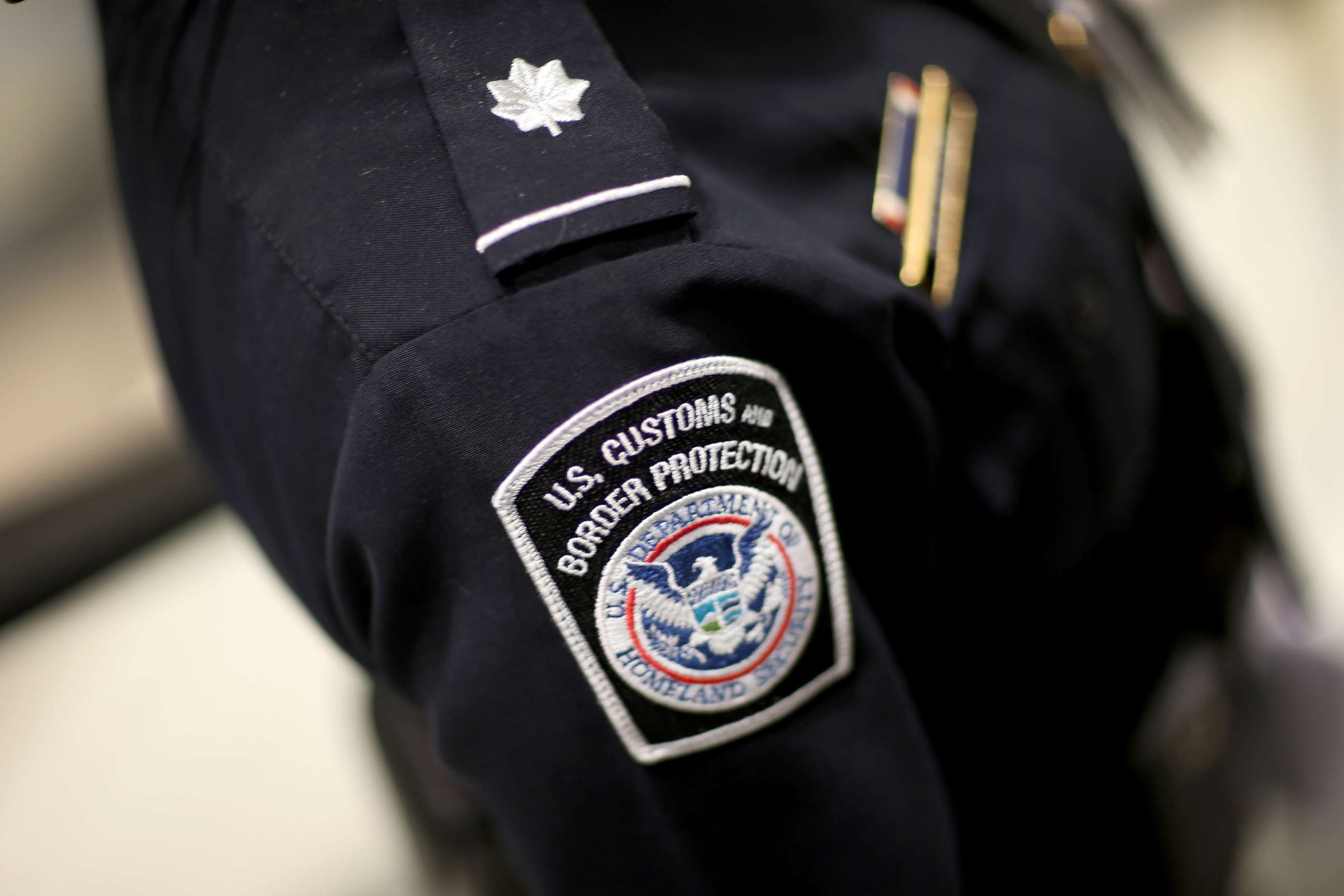 PHOTO: A U.S. Customs and Border Protection officer's patch is seen as they unveil a new mobile app for international travelers arriving at Miami International Airport, March 4, 2015 in Miami. 