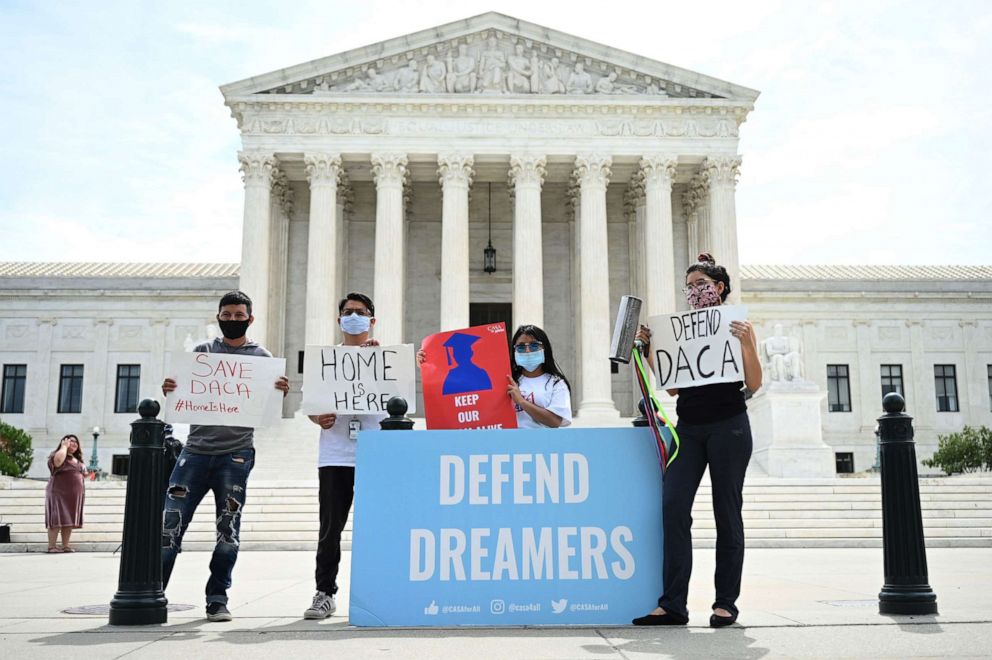 PHOTO: In this file photo Deferred Action for Childhood Arrivals (DACA) demonstrators stand outside the US Supreme Court in Washington, D.C., June 15, 2020. 