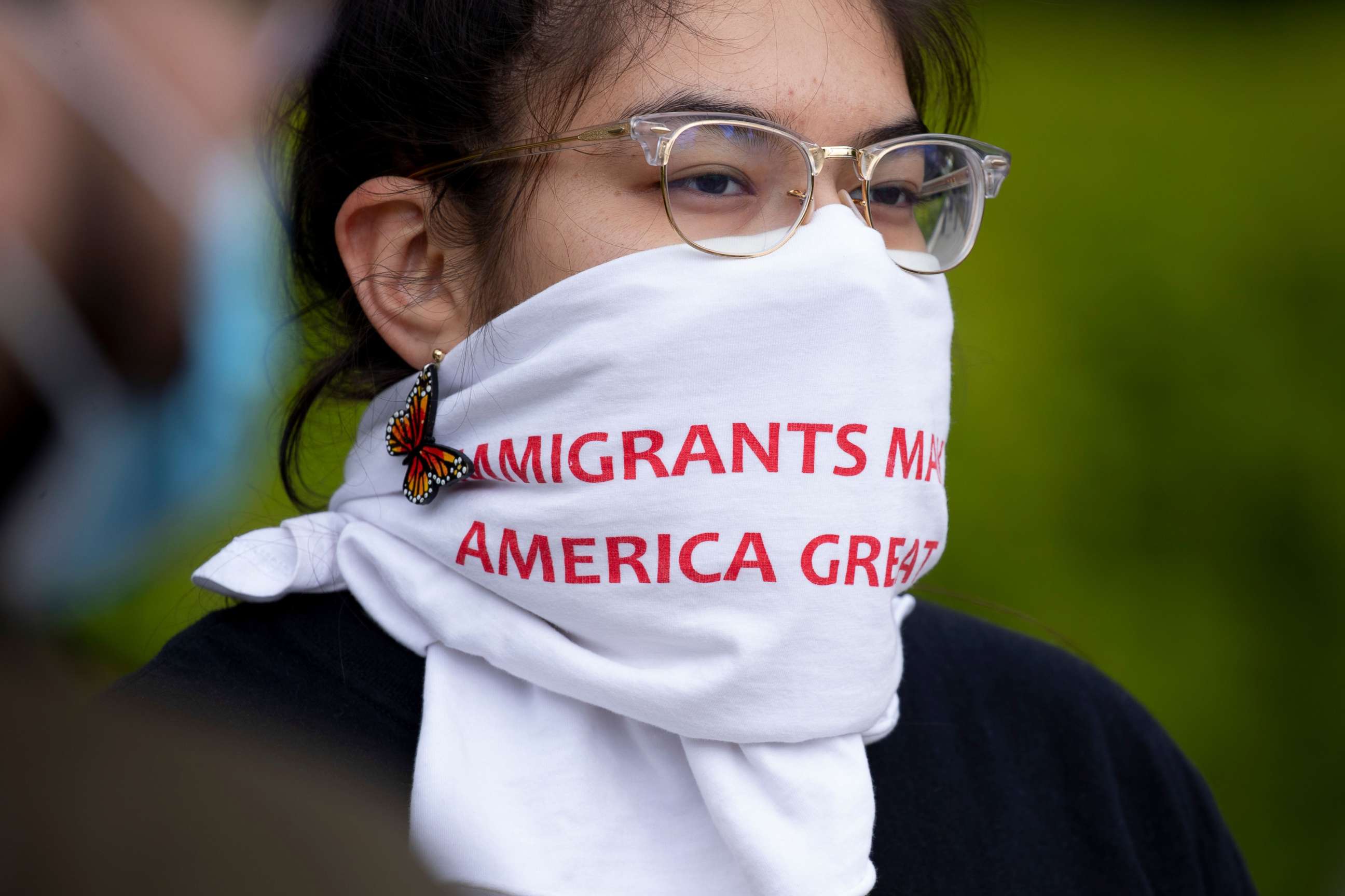 PHOTO: A participant wears a covering on her face that reads "Immigrants Make America Great," during a demonstration held by immigration advocates and 'DREAMers' outside the U.S. Supreme Court in Washington, April 27, 2020.