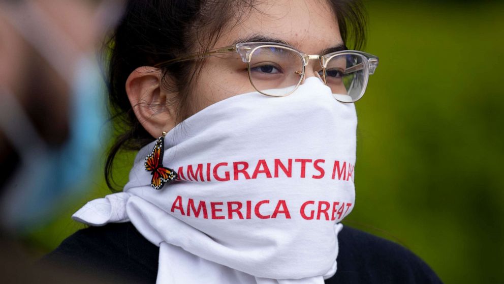 PHOTO: A participant wears a covering on her face that reads "Immigrants Make America Great," during a demonstration held by immigration advocates and 'DREAMers' outside the U.S. Supreme Court in Washington, April 27, 2020.