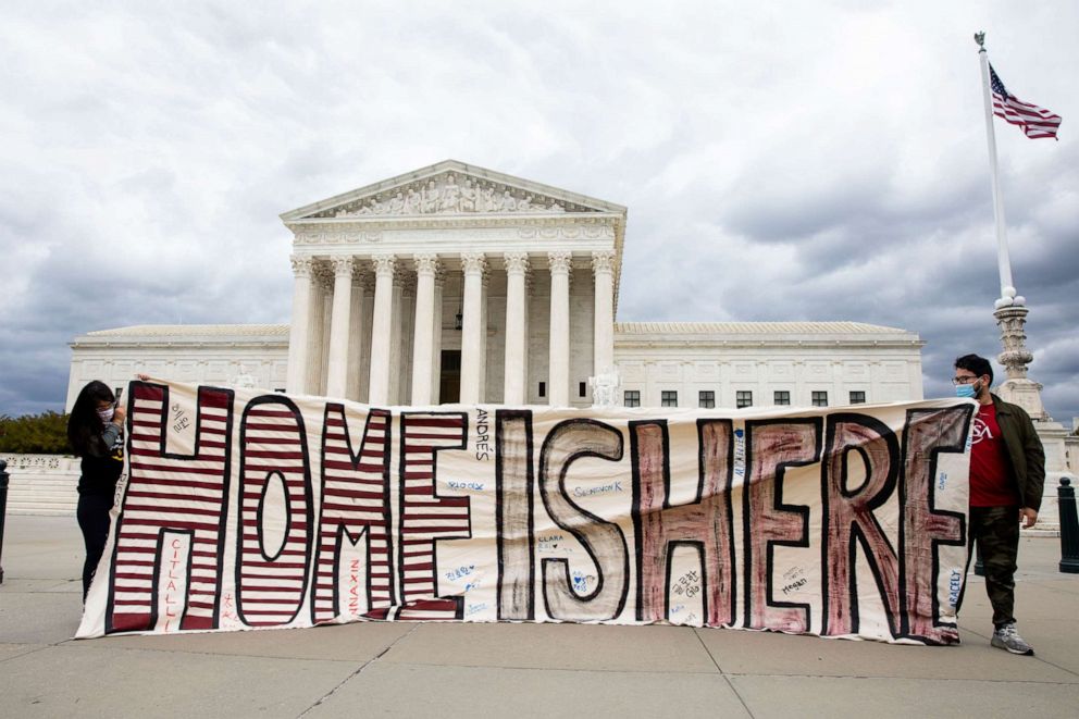 PHOTO: Participants hold a sign that reads "Home is Here" outside the U.S. Supreme Court as part of a demonstration held by immigration advocates and 'DREAMers' in Washington, April 27, 2020.