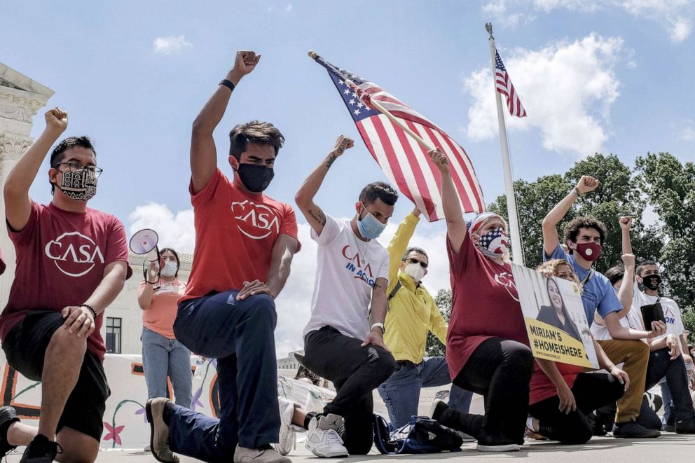 PHOTO:DACA demonstrators hold their fists in the air while kneeling outside the U.S. Supreme Court in Washington,  June 18, 2020. 