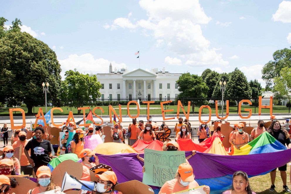 PHOTO: Protesters holding a sign that reads ''DACA Is Not Enough'' stand in front of the White House in Washington, June 15, 2021.