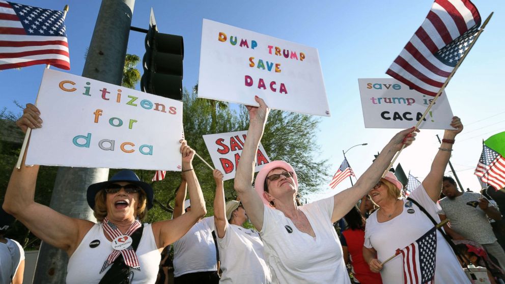 Deborah Shomsky, center, of Nevada joins immigrants and supporters during a "We Rise for the Dream" rally to oppose U.S. President Donald Trump's order to end DACA in Las Vegas, Sept. 10, 2017, in Las Vegas.