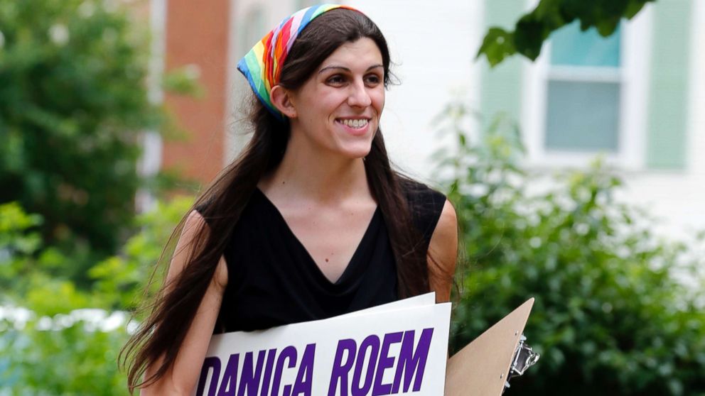 Democratic nominee for the House of Delegates 13th district seat Danica Roem brings campaign signs as she greets voters while canvassing a neighborhood in Manassas, Virginia, June 21, 2017. Roem, a former journalist, is challenging longtime incumbent Bob Marshall. If elected, Roem would be the state's first transgender representative.