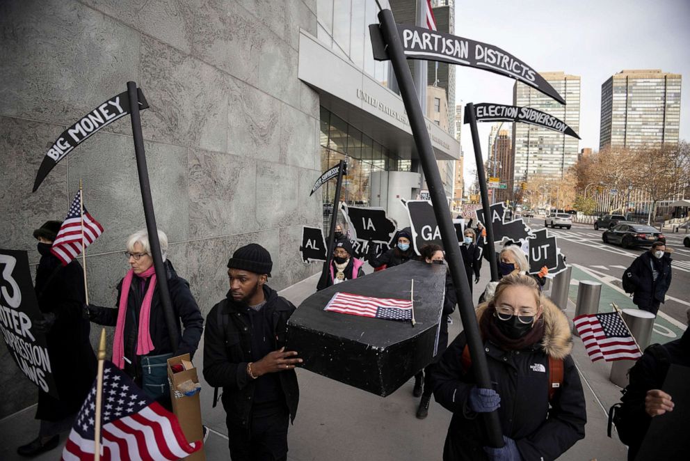PHOTO: Activists from Fair Elections for New York, Black Voters Matter and Workers Circle hold a mock funeral for U.S. democracy and called for federal voting rights legislation outside the United States Mission in New York, Dec. 9, 2021.