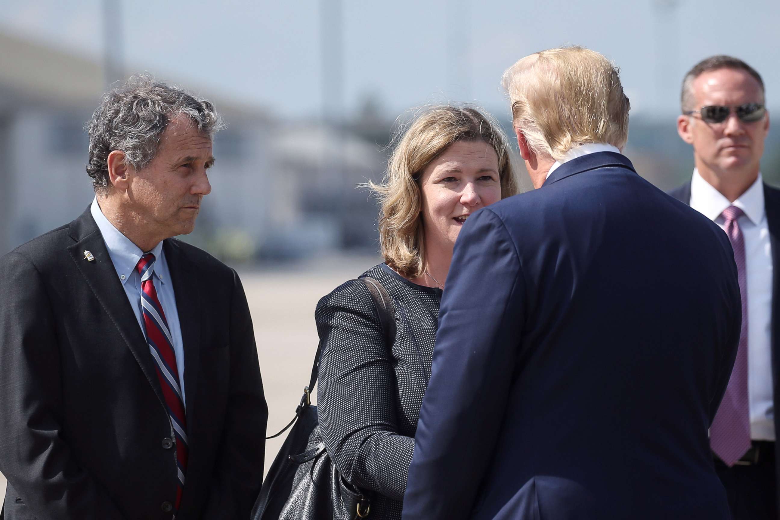 PHOTO: President Donald Trump is greeted by Dayton, Ohio, Mayor Nan Whaley as 
Sen. Sherrod Brown waits at left, as Trump arrived at Wright-Patterson Air Force Base before visiting the site of a mass shooting in Dayton, Ohio, Aug. 7, 2019.