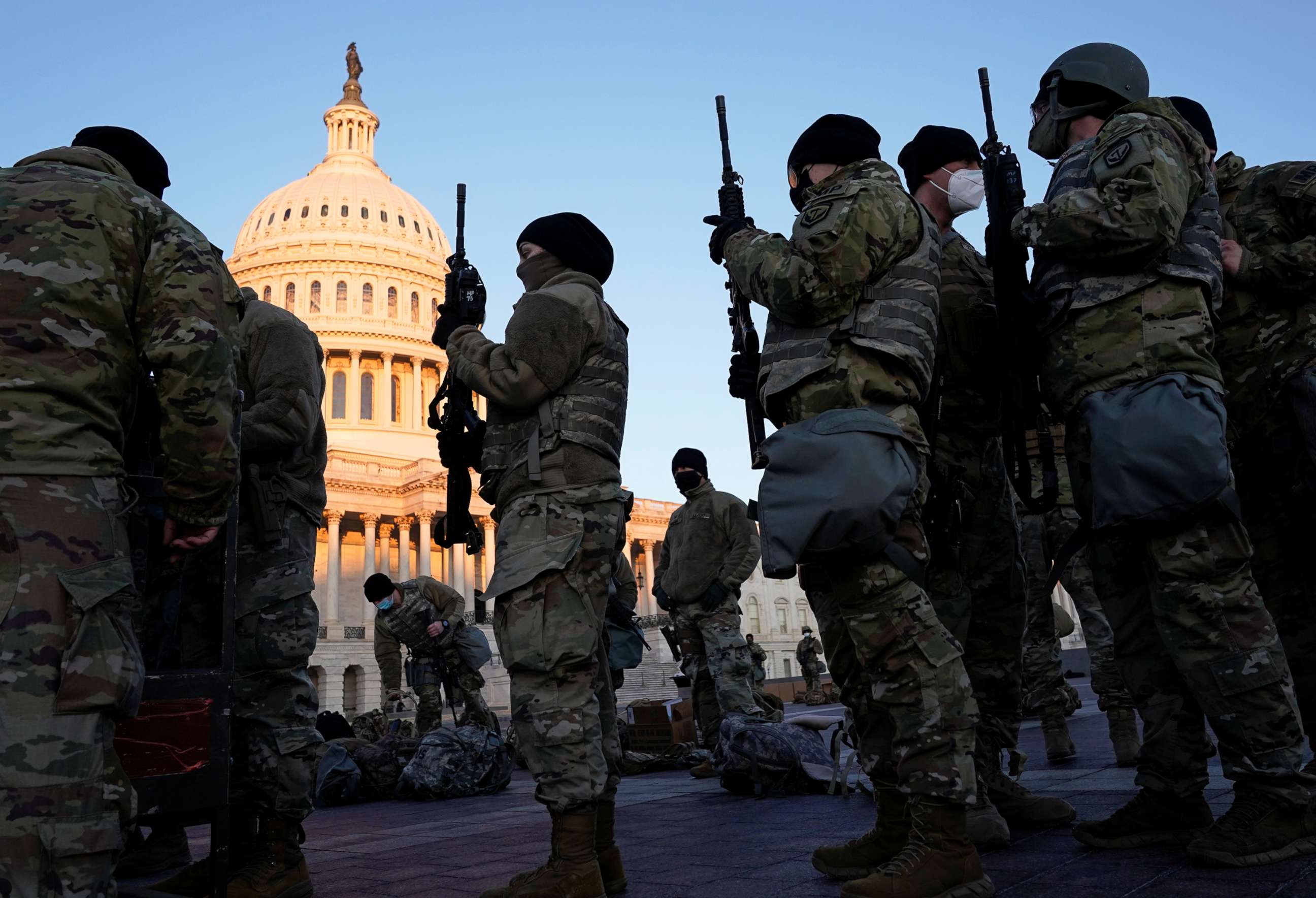 PHOTO: Members of the National Guard are given weapons before Democrats begin debating one article of impeachment against President Trump at the Capitol, in Washington, D.C., Jan. 13, 2021.