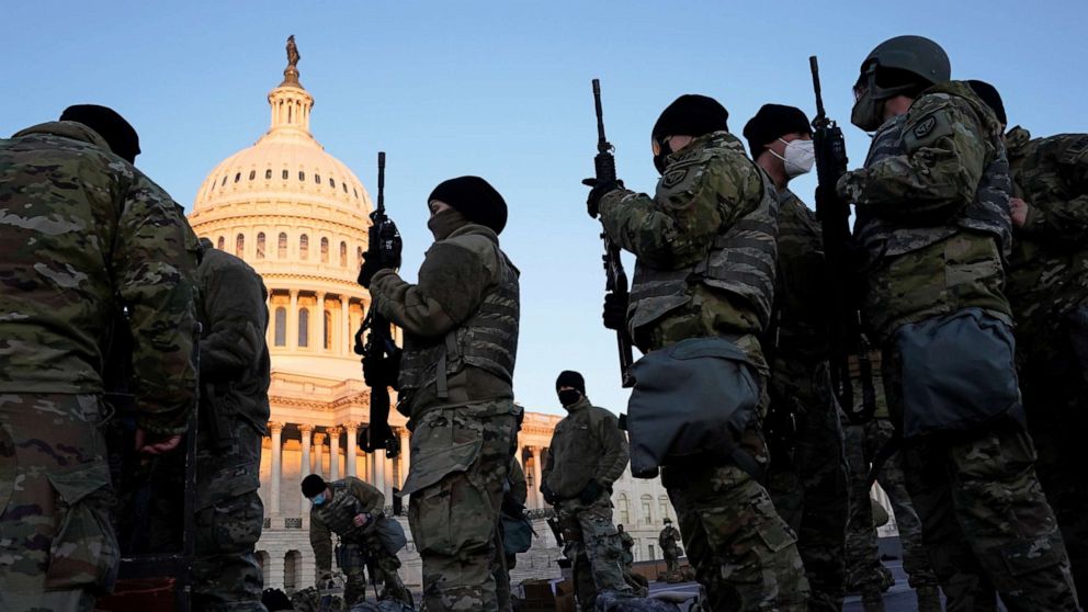 PHOTO: Members of the National Guard are given weapons before Democrats begin debating one article of impeachment against President Trump at the Capitol, in Washington, D.C., Jan. 13, 2021.