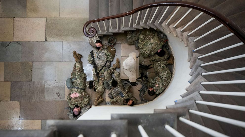 PHOTO: Members of the National Guard try to get some sleep inside the US Capitol in Washington, D.C., Jan. 13, 2021.