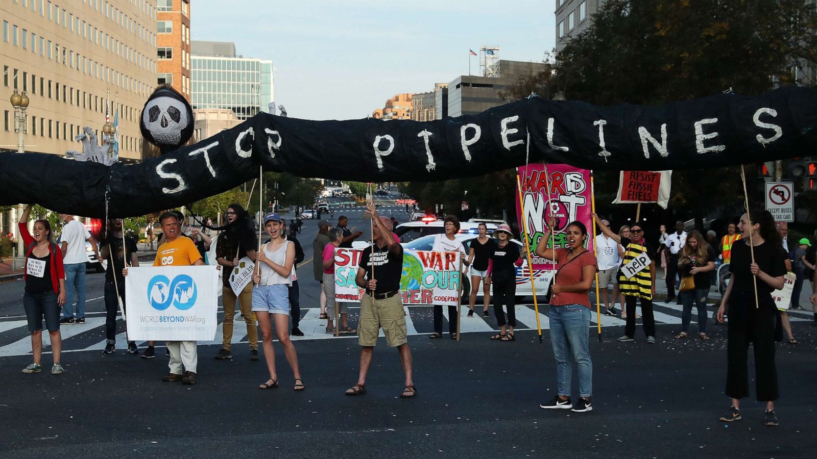 Protester with climate change banner crashes Louis Vuitton show