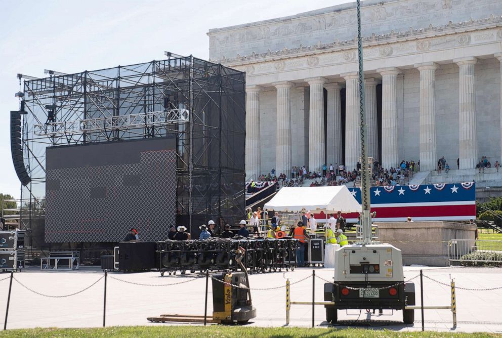 PHOTO: Workers build a stage and bleachers for the "Salute to America" Fourth of July event at the Lincoln Memorial on the National Mall in Washington, DC, July 1, 2019.