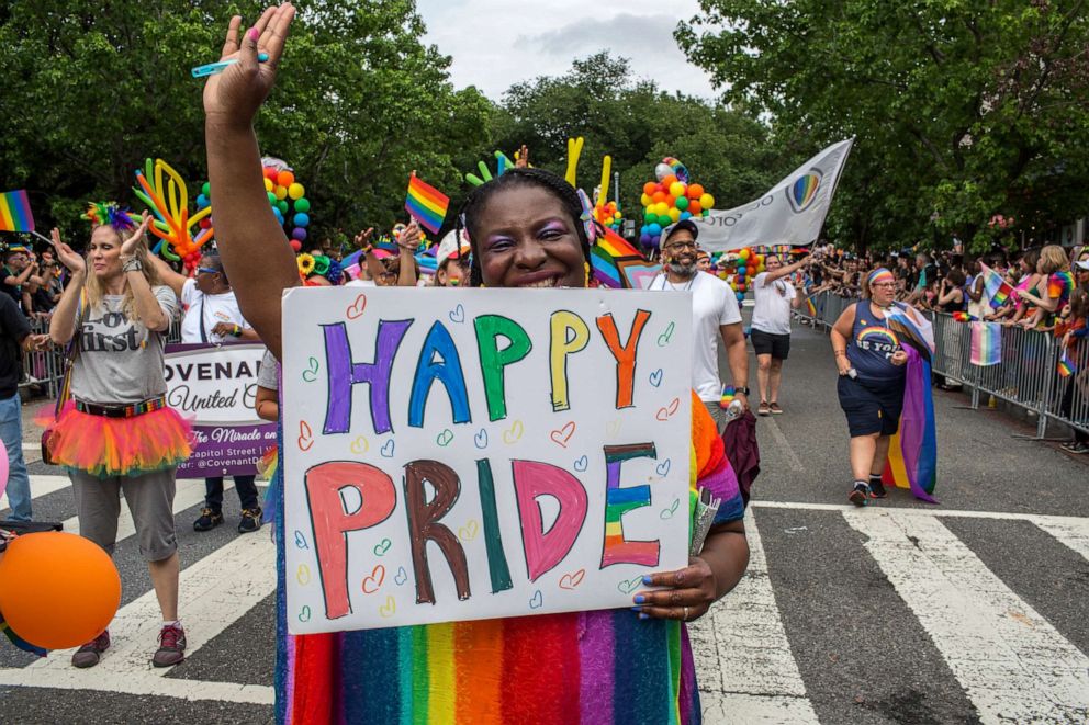 PHOTO: A woman holding a sign with Happy Pride written on it during the annual Pride Parade celebrations in Washington DC, June 11, 2022.