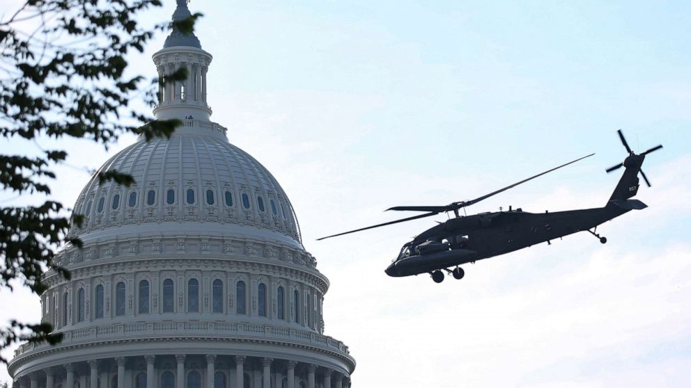PHOTO: Black Hawk UH-60 Lima U.S. military helicopters perform in a routine training exercise at the Capitol in Washington, D.C., June 7, 2021.