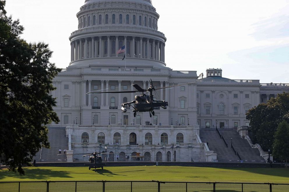 PHOTO: Black Hawk UH-60 Lima U.S. military helicopters perform in a routine training exercise at the Capitol in Washington, D.C., June 7, 2021.